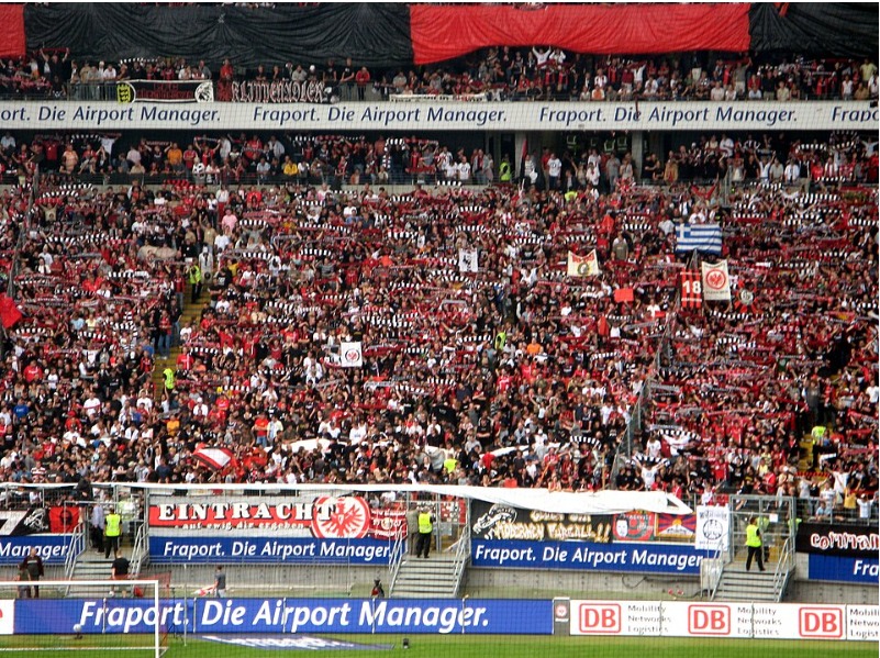 Fans holding scarves aloft in the west stand (Westkurve) of the stadium
