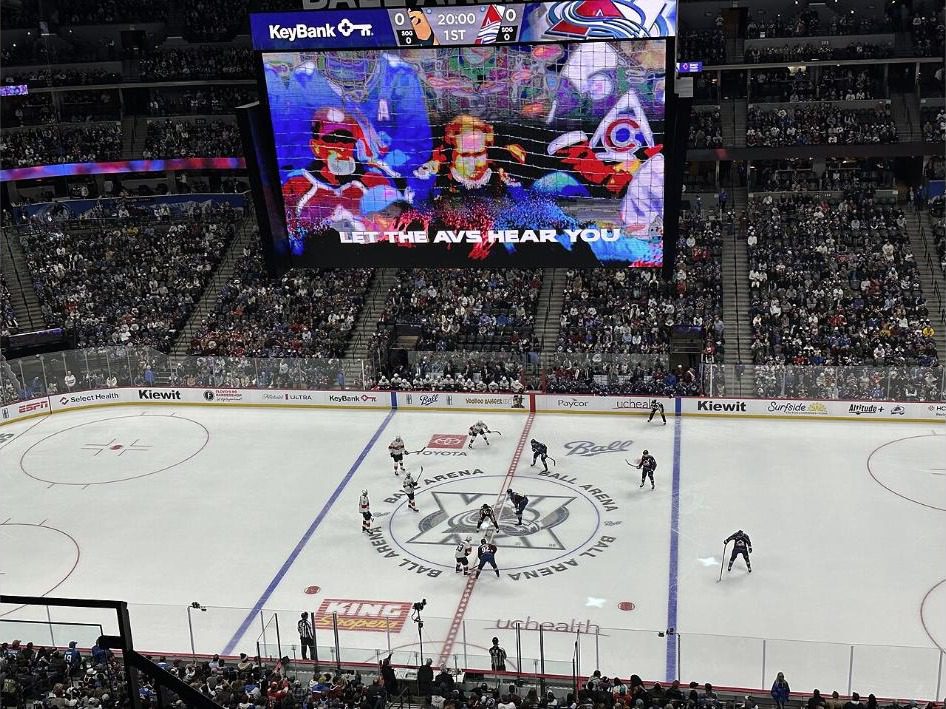 Interior of Ball Arena set up for hockey, with sponsor boards running along the boards