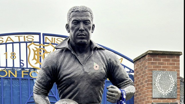 Dixie Dean statue in front of the blue Everton gates with the club crest