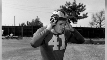 Fred Gehrke putting on a Rams helmet with hand-painted horns, 1948