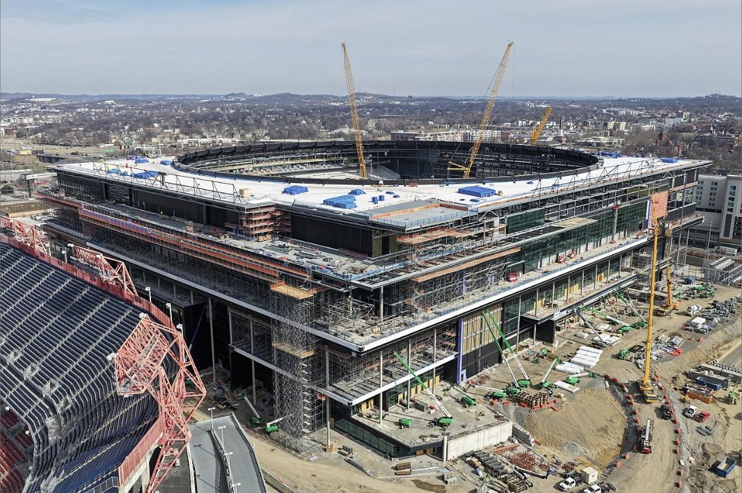 The new Nissan Stadium under construction, with seats of the existing stadium at lower left