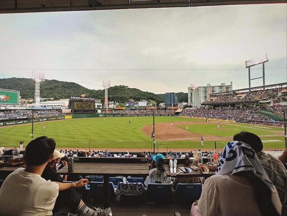 An Eagles game seen from the lower stands on the third-base side of the old Daejeon Hanbat Baseball Stadium, with Bomunsan mountain behind