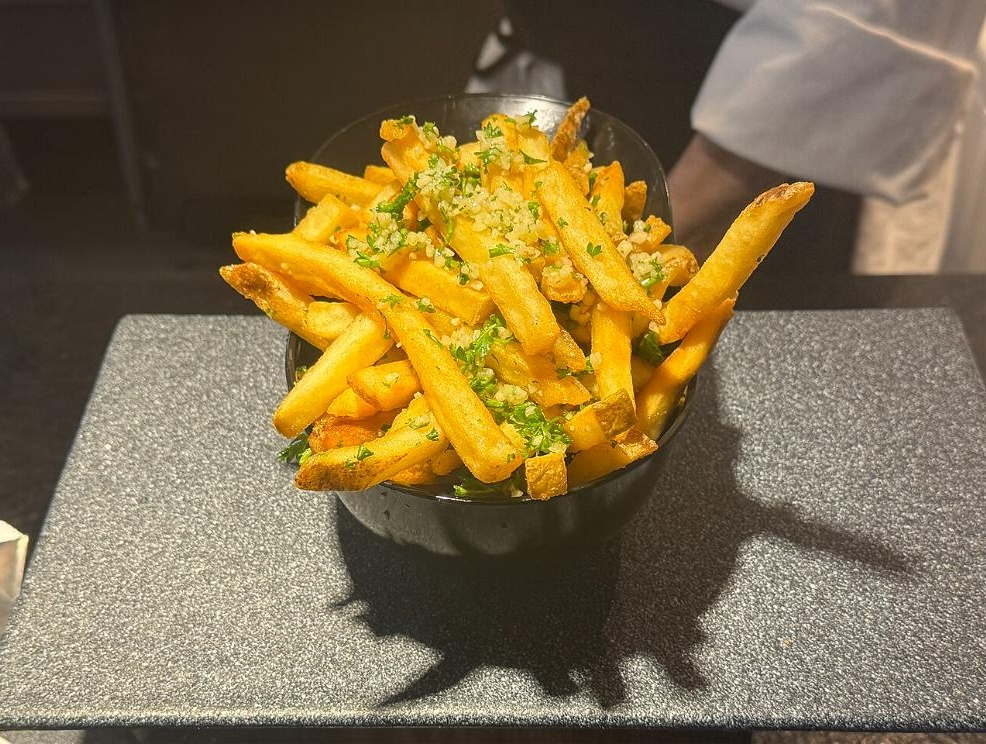 Gilroy garlic fries served in a black bowl