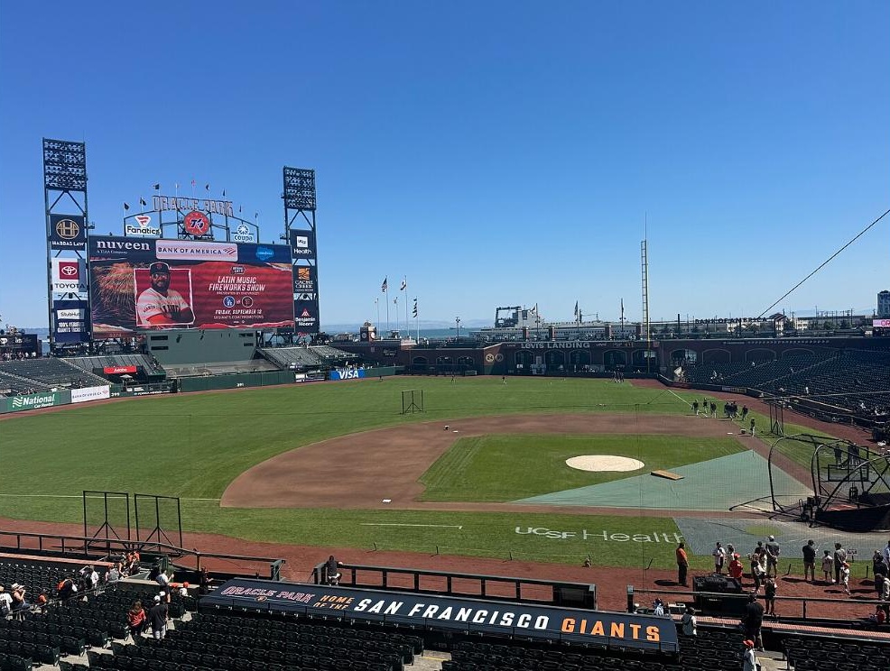 The Oracle Park scoreboard and outfield seen from the infield stands before a game